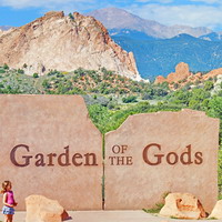 Audrey contemplating the Garden of the Gods sign.