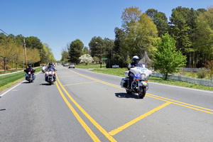 CMPD officer keeping the Thin Blue Line safe, riding past on the outside.