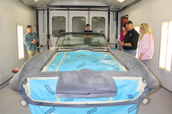 The LMC team discussing the work to be done on Jody's car before donating it to the Make a Wish Foundation of Canada.